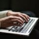 Woman's hands on laptop keyboard